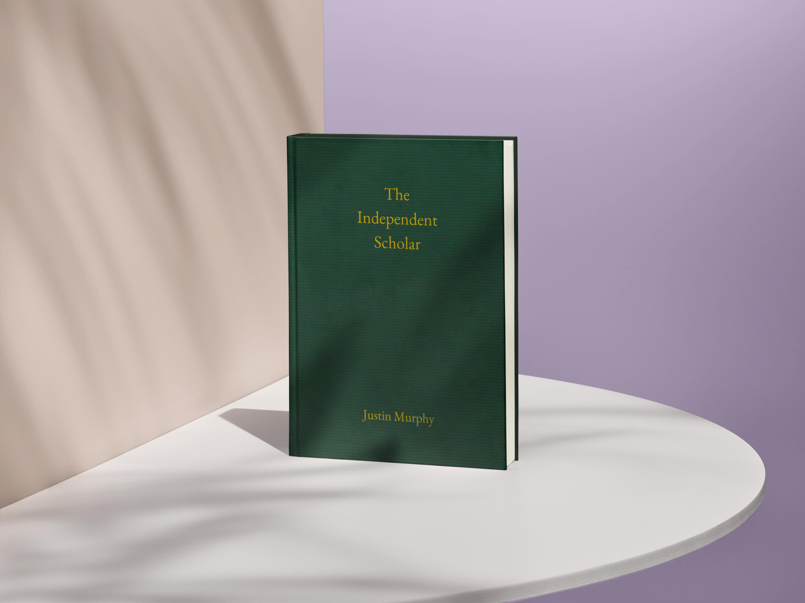 Green hardcover copy of The Independent Scholar standing on a white table.